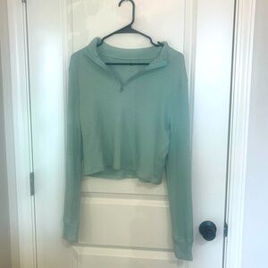 Cropped teal long sleeve. XL but fits like a regular medium.